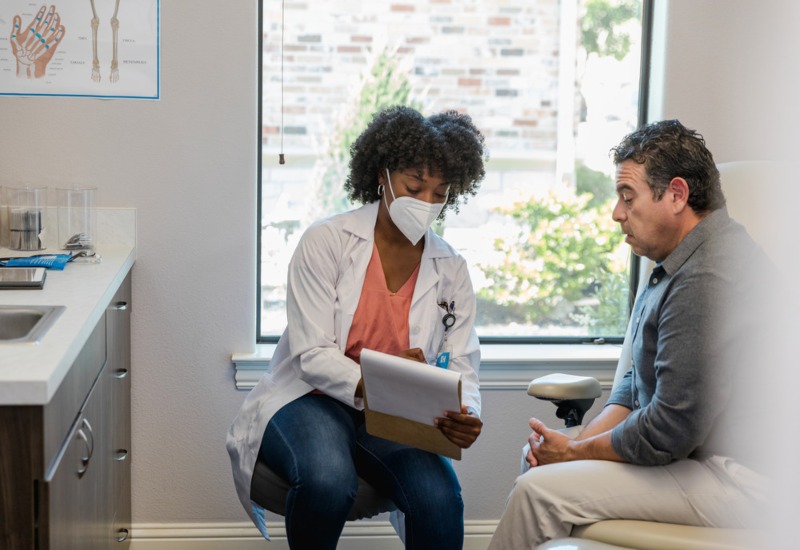 Doctor Showing a Diagram of the Gastrointestinal Tract for Inflammatory Bowel Disease Treatment in Atlanta, GA